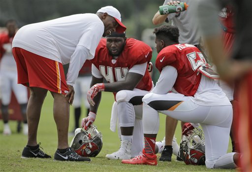 Tampa Bay Buccaneers linebackers coach Hardy Nickerson, left, talks to Courtland Clavette and Kwon Alexander, right, during a Buccaneers training camp practice Tuesday, Aug. 4, 2015, in Tampa, Fla. (AP Photo/Chris O'Meara)