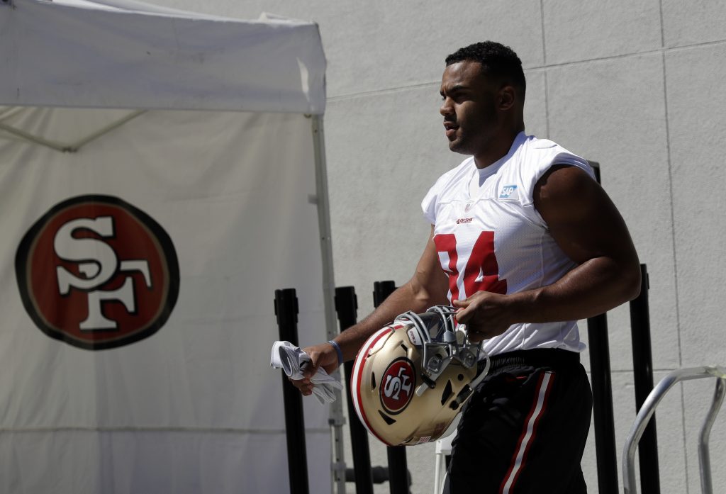 Defensive End Solomon Thomas walks to the practice field during 49ers training camp