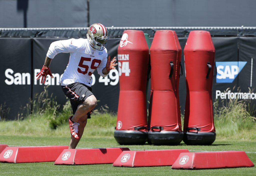 Defensive End Aaron Lynch warms up before 49ers practice