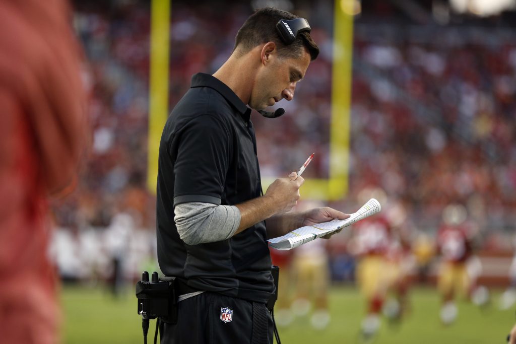 Head coach Kyle Shanahan looks at his play sheet during the 49ers preseason game against the Broncos
