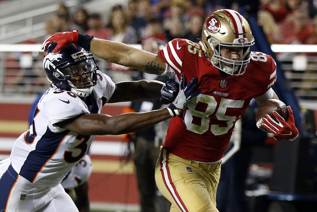 Tight end George Kittle breaks a tackle during the 49ers preseason game against the Broncos
